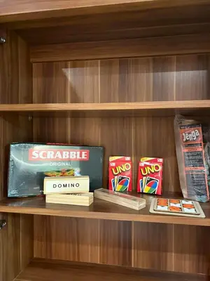 a book shelf with books and snacks on it at La Casa 543 in Manila