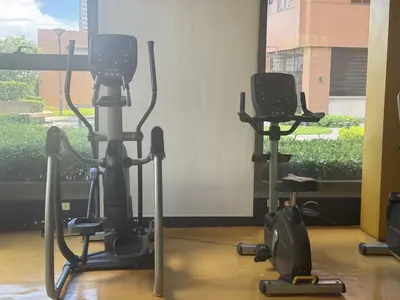 a gym with two exercise bikes in a room at Levi & Moon's Manila Bay in Manila