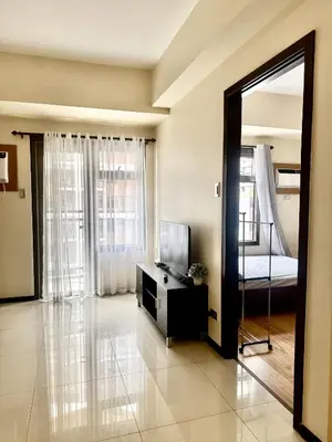 a living room with a mirror and a bed at Levi & Moon's Manila Bay in Manila