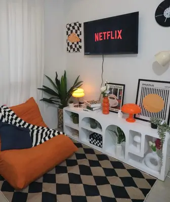 a living room with a couch and a tv on a wall at Modern Retro Stay near NAIA 3 in Manila
