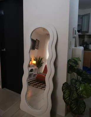 a hallway with a mirror in a living room at Modern Retro Stay near NAIA 3 in Manila