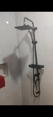 a shelf with a hose on a wall at Auntie's in Tanza