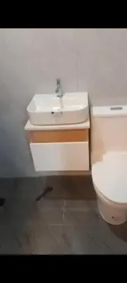a bathroom with a white sink and a toilet at Auntie's in Tanza