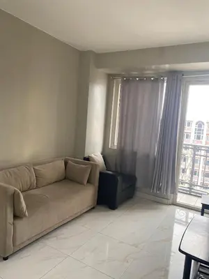 a living room with a couch and a large window at Monarch Park Suites WS in Manila