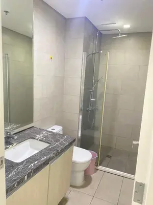 a bathroom with a shower and a sink and a toilet at Monarch Park Suites WS in Manila