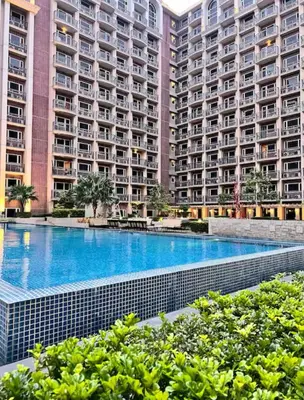 a large apartment building with a large swimming pool at Monarch Park Suites WS in Manila