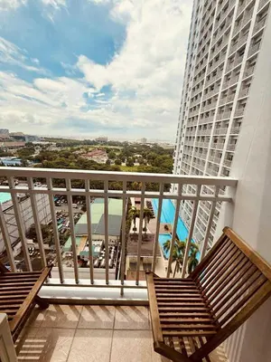 a balcony with two benches and a view of a building at Breeze Staycation by Charmed in Sampong