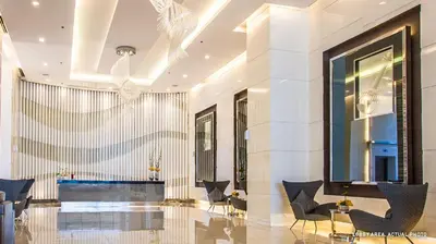 a lobby of a building with chairs and a table at High Rise 2br In the Makati Skyline with KTV Pools in Manila