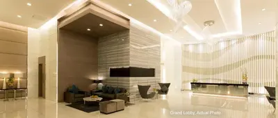 a living room with a fireplace and a tv at High Rise 2br In the Makati Skyline with KTV Pools in Manila