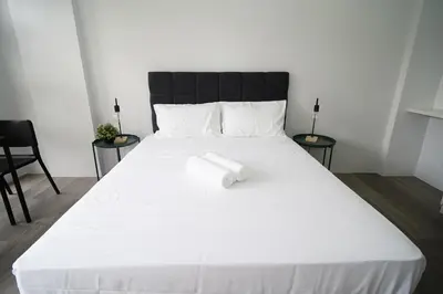 a large white bed with a white towel on it at 20 Boeing Apt in Manila
