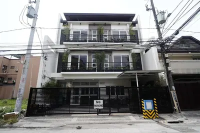 a white house with a black gate and a no entry sign at 20 Boeing Apt in Manila