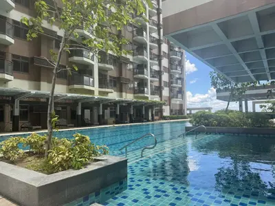 a swimming pool in front of a building at Levi & Moon Relax and Chill in Manila