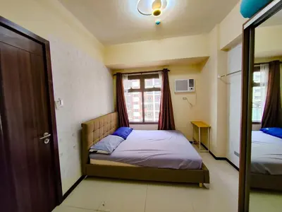 a bedroom with two beds and a window at Levi & Moon Relax and Chill in Manila