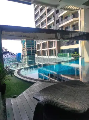 a swimming pool in the middle of a building at Condo Living - Pool, Balcony, Gym, Fast WiFi in Manila