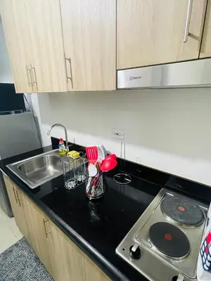 a kitchen with a sink and a counter top at Shore Residences Moa Pasay in Manila