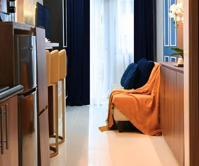 a room with a couch with a blanket on it at Chic & Cozy Urban Stay in Manila