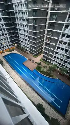 an overhead view of a swimming pool in front of two large buildings at Chic & Cozy Urban Stay in Manila