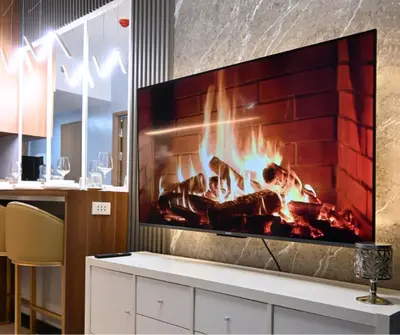 a fireplace in a living room with a tv at Chic & Cozy Urban Stay in Manila