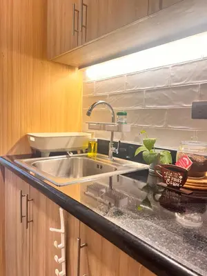 a kitchen with a sink and a counter top at Condo Living at Shore with Parking in Manila