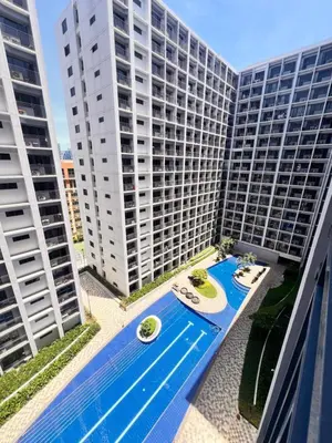 an overhead view of a large building with a swimming pool at Condo Living at Shore with Parking in Manila