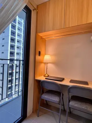 a room with a desk with two chairs and a window at Condo Living at Shore with Parking in Manila