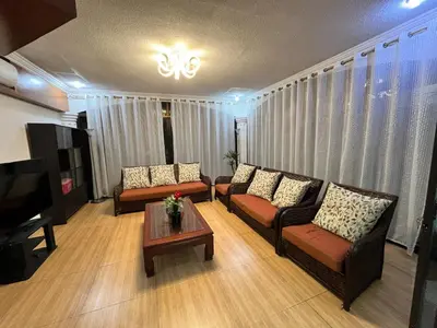 a living room with two couches and a coffee table at Elegant 5BR Home Near BGC in Manila