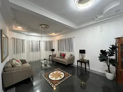 a living room with two couches and a table at Elegant 5BR Home Near BGC in Manila