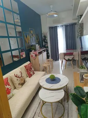 a living room with a couch and a table at SkyShore Suites in Manila