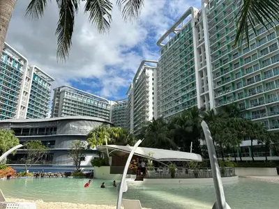 a swimming pool in front of some tall buildings at Azure Urban Resort Residences - St Tropez Tower in Manila