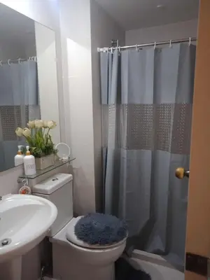 a bathroom with a toilet and a sink and a shower at Azure Urban Resort Residences - St Tropez Tower in Manila