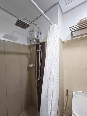 a shower in a bathroom with a shower curtain at Maison dela Mer SMDC Breeze Residences Pasay in Manila