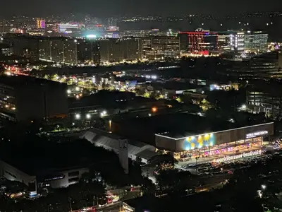 a view of a city at night with lights at Maison dela Mer SMDC Breeze Residences Pasay in Manila