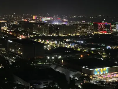 a view of a city at night with lights at Maison dela Mer SMDC Breeze Residences Pasay in Manila