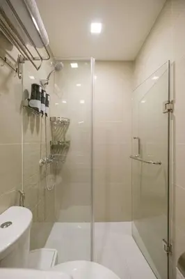 a bathroom with a shower and a toilet and a sink at Luxurious Maison at 81 Newport near Terminal 3 Airport in Manila