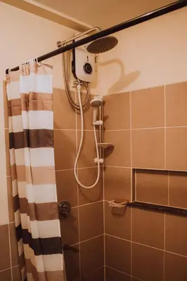 a shower with a shower head in a bathroom at Cozy 1BR Staycation at Satori Residences, Pasig in Manila