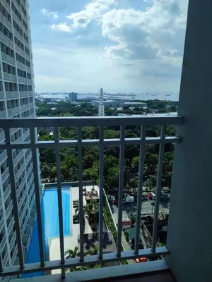 a view of the city from a balcony of a building at Pasay Staycation manila bay view in Manila