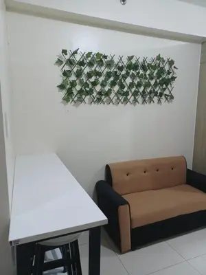 a living room with a couch and a table at Pasay Staycation manila bay view in Manila