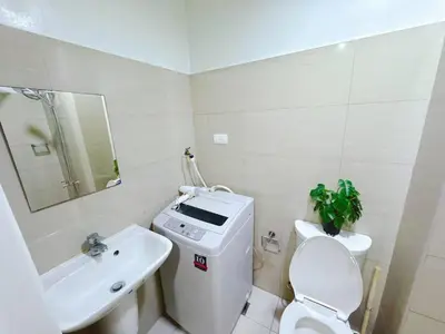 a white bathroom with a toilet and a sink at SHORE 2 TOWER 2 7th floor Near MOA Easy Vacation Shopping Center in Manila