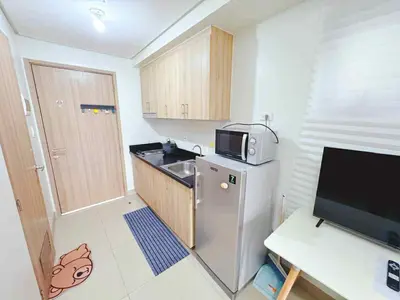a small kitchen with a refrigerator and a microwave at SHORE 2 TOWER 2 7th floor Near MOA Easy Vacation Shopping Center in Manila