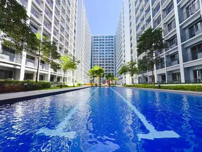 a blue swimming pool in a city with tall buildings at SHORE 2 TOWER 2 7th floor Near MOA Easy Vacation Shopping Center in Manila