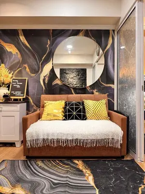 a living room with a couch and a wall mural at Horiyama staycation azure in Manila