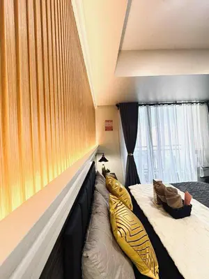 a bedroom with a bed with a boat pillow on it at Horiyama staycation azure in Manila