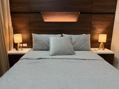 a bedroom with a large bed with two lamps at Luxury 2BR w Balcony BGC Taguig near Venice Mall in Manila