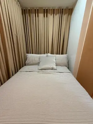 a large bed in a room with curtains at Luxury 2BR w Balcony BGC Taguig near Venice Mall in Manila