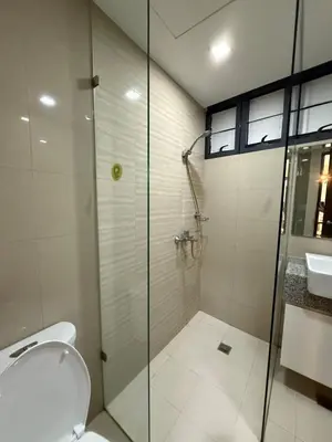 a bathroom with a shower and a toilet and a sink at Luxury 2BR w Balcony BGC Taguig near Venice Mall in Manila