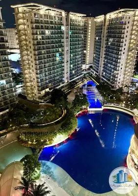an overhead view of a large pool in a city at night at Azure Urban Resort Residences by Amóre Suites in Manila