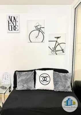 a bedroom with three drawings of a bike on the wall at Azure Urban Resort Residences by Amóre Suites in Manila