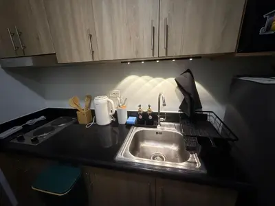 a kitchen with a sink and a counter top at The Nook in Pasay in Manila