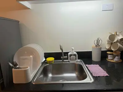 a kitchen counter with a sink and a sink at Sea Residences Condotel With Balcony, by Rose in Manila