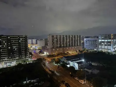 a city with tall buildings and a street at night at Sea Residences Condotel With Balcony, by Rose in Manila